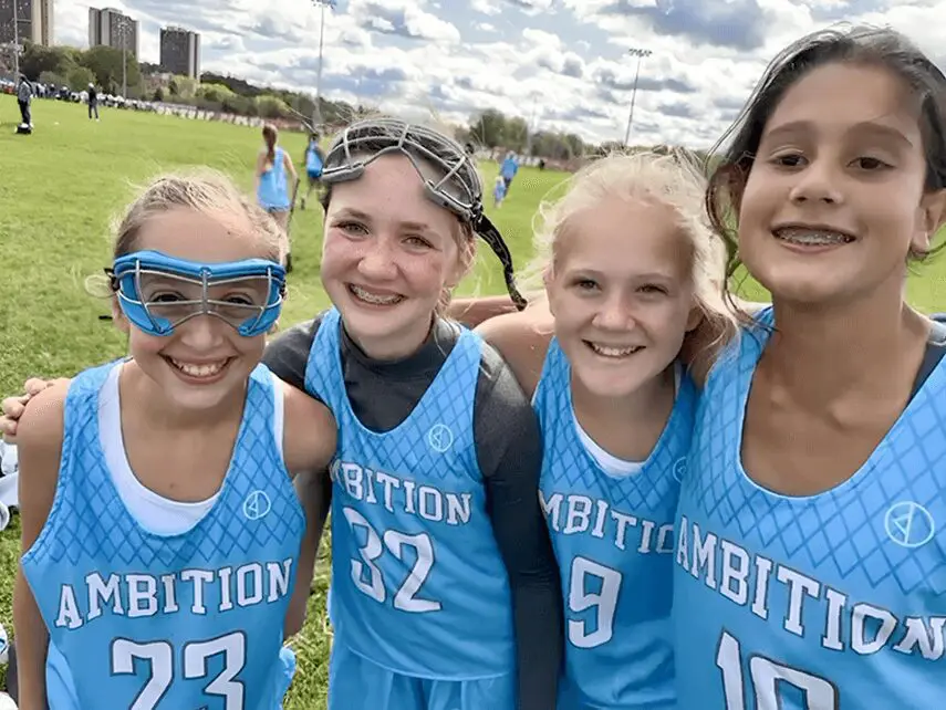 A group of girls in blue jerseys posing for the camera.